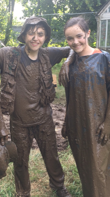 King's InterHigh pupil & actor, Gene Gurie, covered head to toe in mud with his elbow on a girl's shoulder.