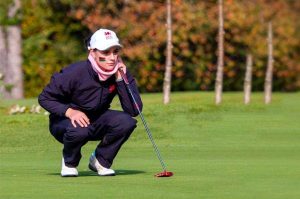 Student and golfer, Darcy, watches a golf ball from across the green.