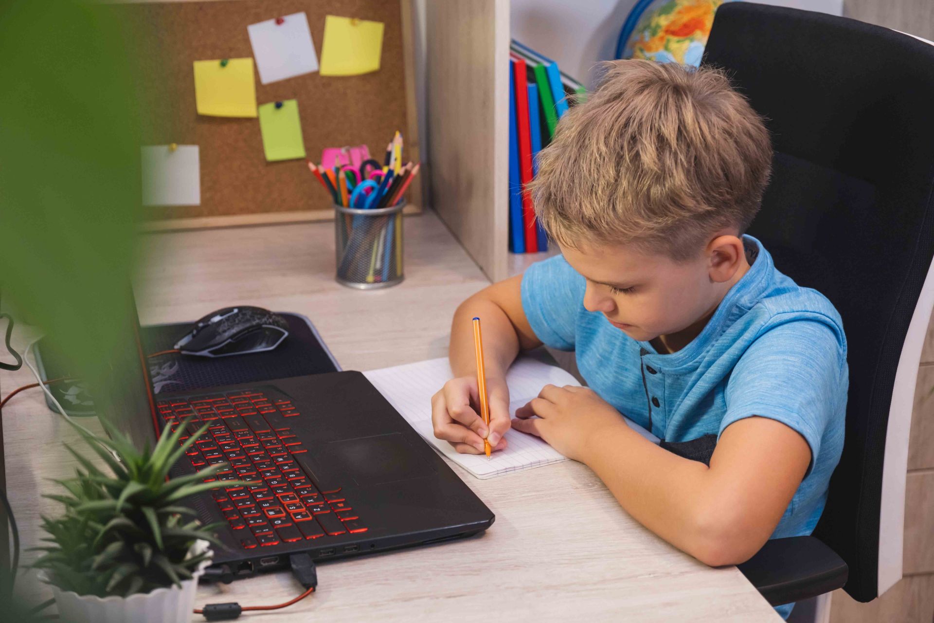 Student doing his homework at his online school